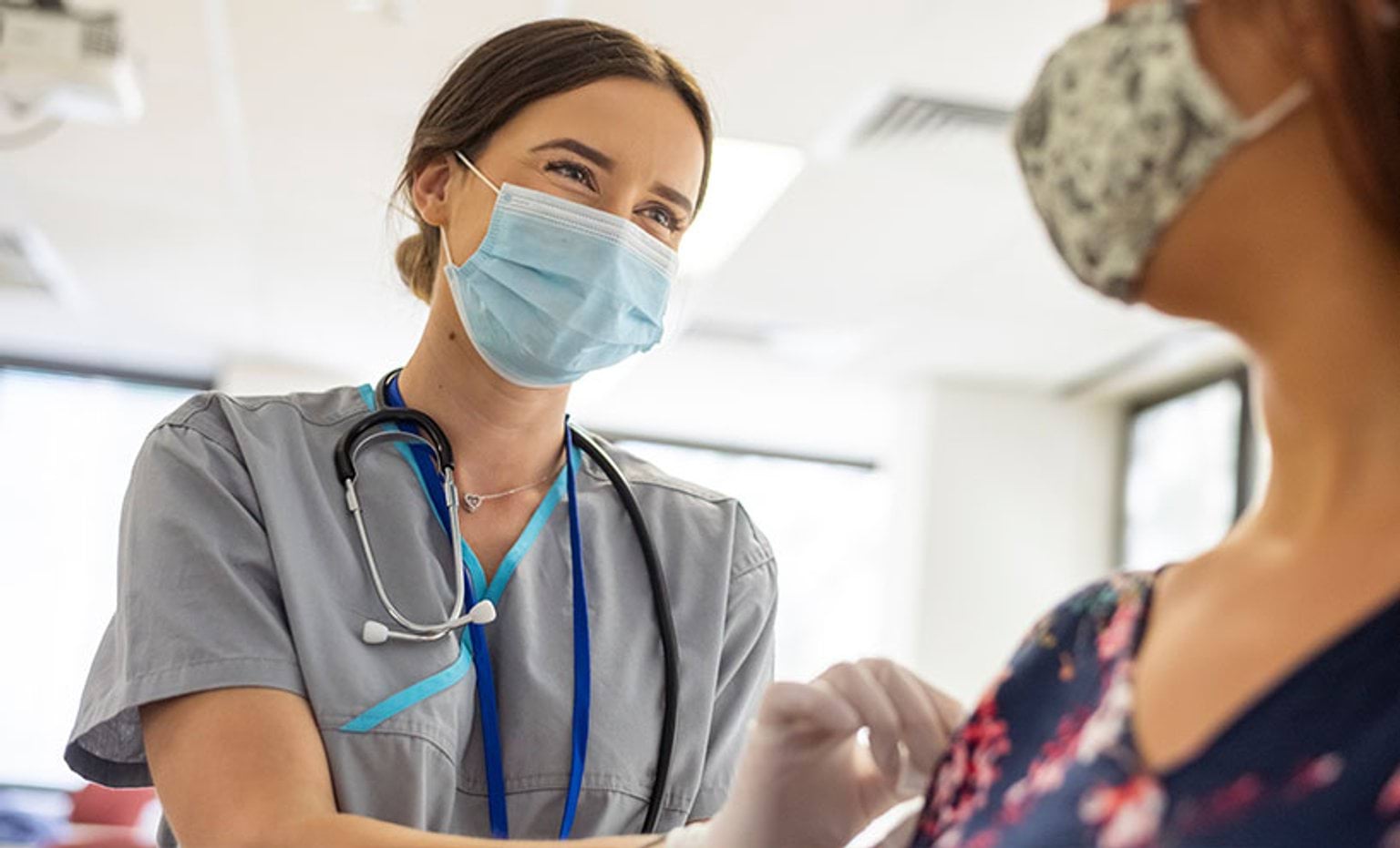 Image of a nurse looking after her patient