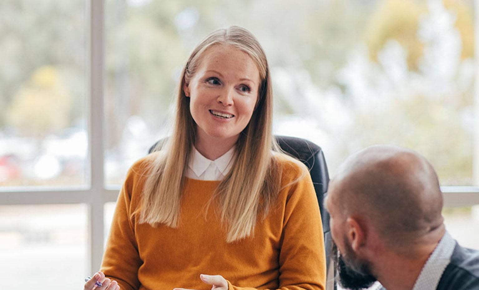 woman sitting talking to another person