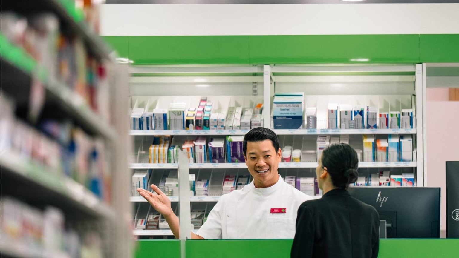 A pharmacist greets a customer